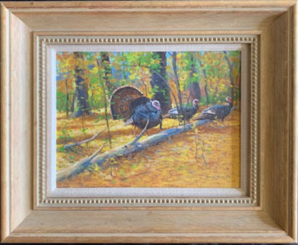 Framed oil painting of a turkey gobbler and two hens perched on a log in a forest in autumn.